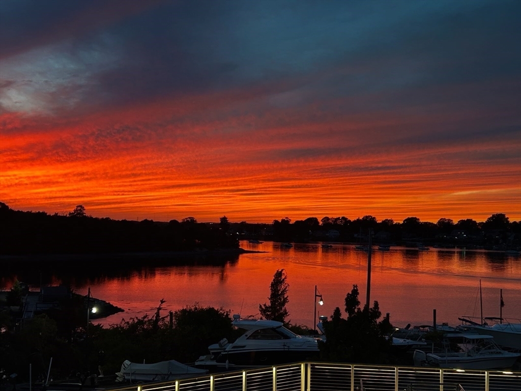 10 Shipyard Drive, Unit 313 Hingham, MA 02043 - Photo 2 of 39 a view of lake and sunset