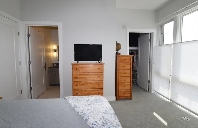a view of walk in closet with furniture and a window