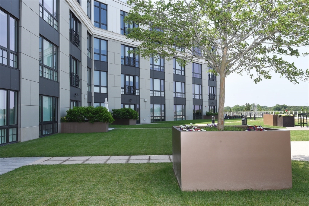 10 Shipyard Drive, Unit 313 Hingham, MA 02043 - Photo 27 of 39 a view of a tall building with a yard