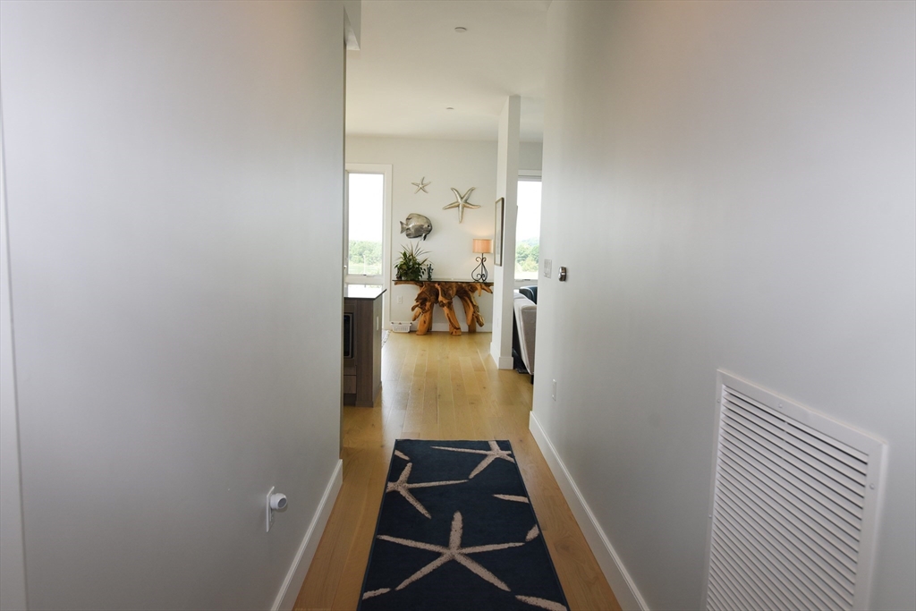 10 Shipyard Drive, Unit 313 Hingham, MA 02043 - Photo 3 of 39 a view of hallway with livingroom and furniture