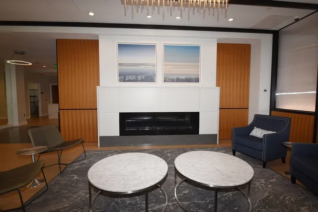 a living room with furniture a fireplace and a table