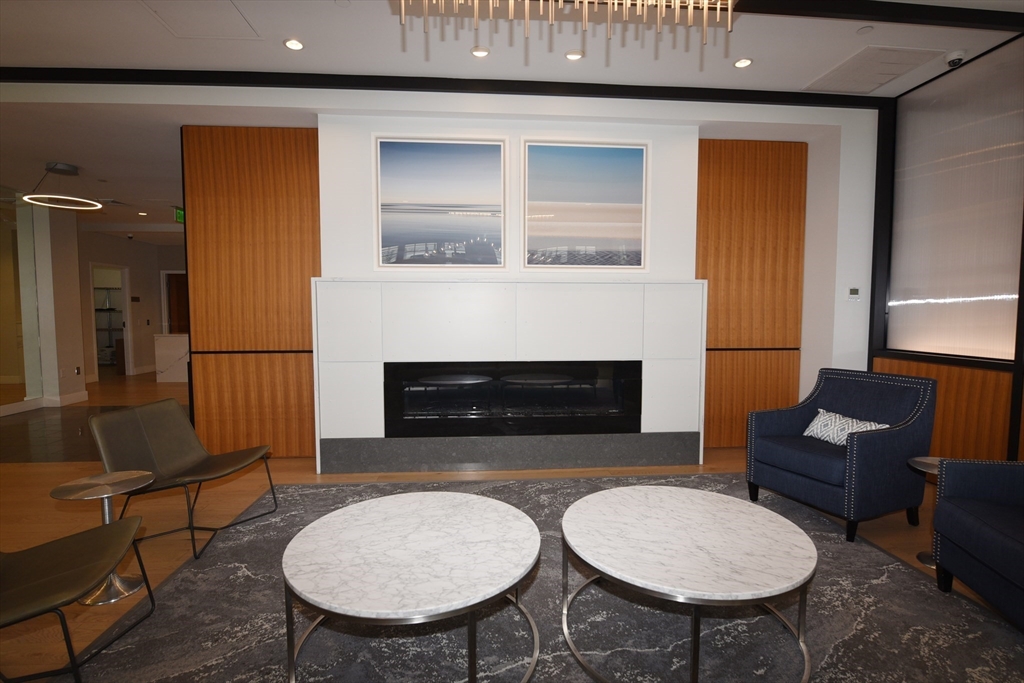 10 Shipyard Drive, Unit 313 Hingham, MA 02043 - Photo 32 of 39 a living room with furniture a fireplace and a table