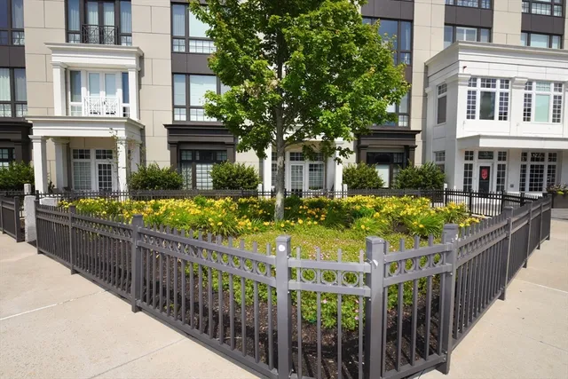 a view of a house with wooden fence