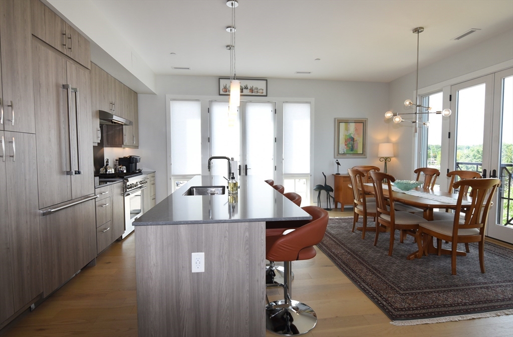 10 Shipyard Drive, Unit 313 Hingham, MA 02043 - Photo 7 of 39 a view of a dining room and livingroom with furniture window and wooden floor
