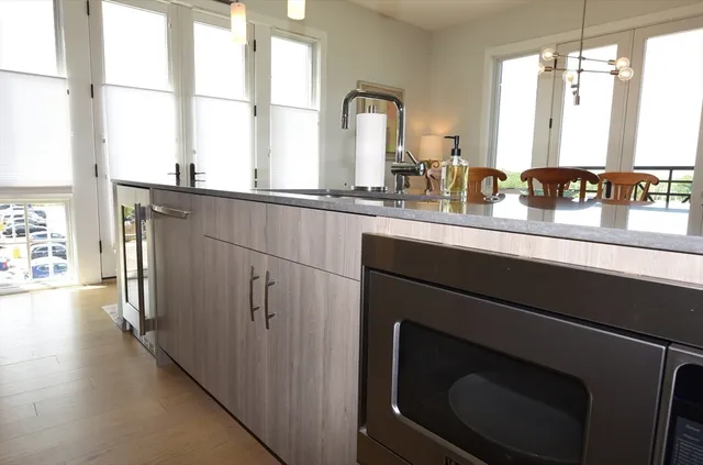 a kitchen with stainless steel appliances a sink stove and a window
