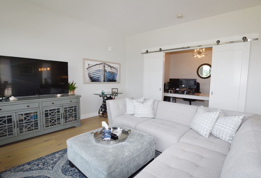 10 Shipyard Drive, Unit 313 Hingham, MA 02043 - Photo 10 of 39 a living room with furniture and a flat screen tv