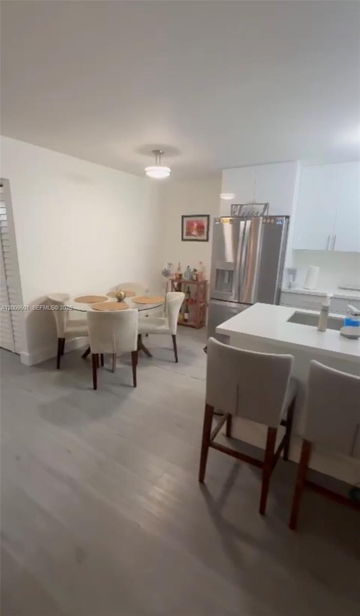 931 Lyons Road, Unit 4101 Coconut Creek, FL 33063 - Photo 13 of 23 a bedroom with furniture and a lamp