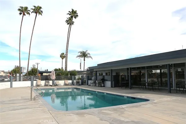 a house with swimming pool in front of it