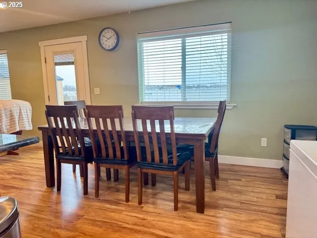 a view of a dining room with furniture window and wooden floor