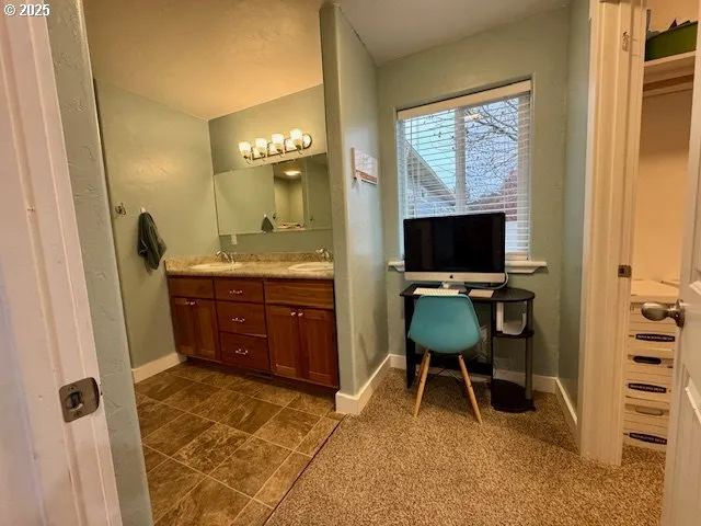 a living room with furniture a flat screen tv and a window