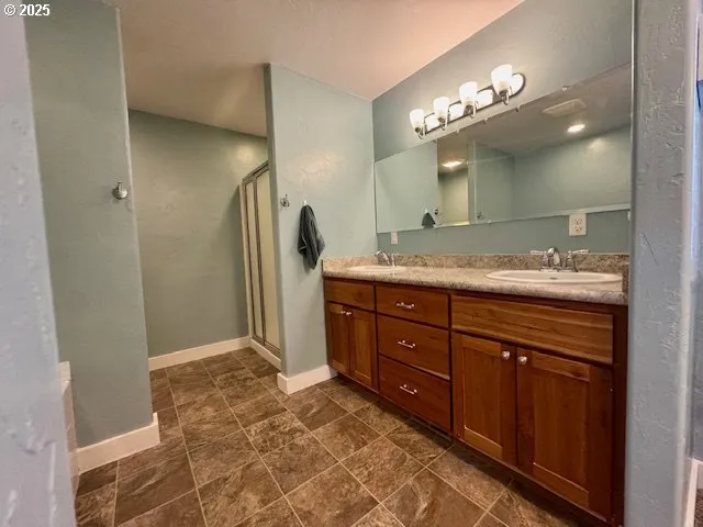 a spacious bathroom with a granite countertop sink and a mirror