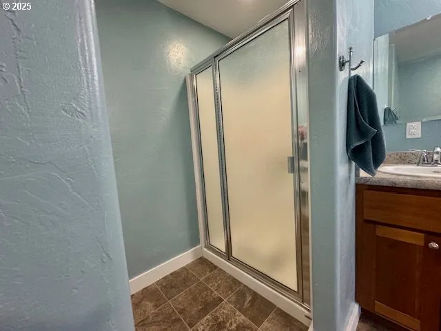 a bathroom with a shower and a sink