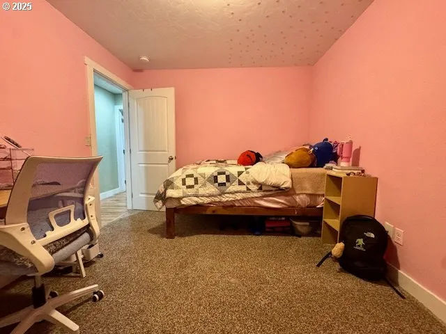 a bedroom with furniture and a dresser