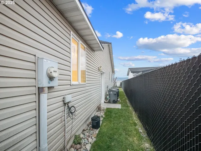 a view of a backyard with table and chairs and a large tree