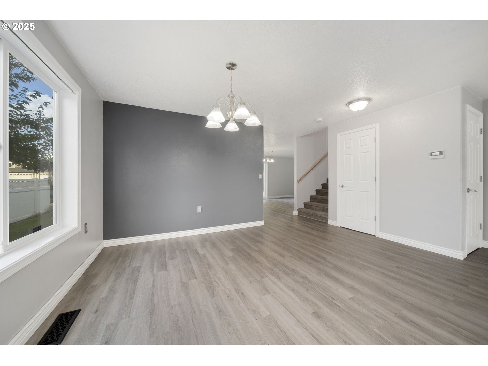 1311 Northwest 26th Avenue Battle Ground, WA 98604 - Photo 12 of 44 a view of an empty room with wooden floor and a window
