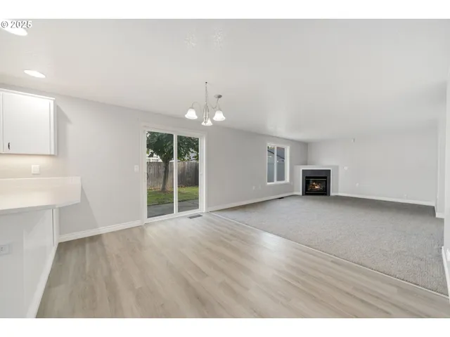 a view of a livingroom with wooden floor and a ceiling fan