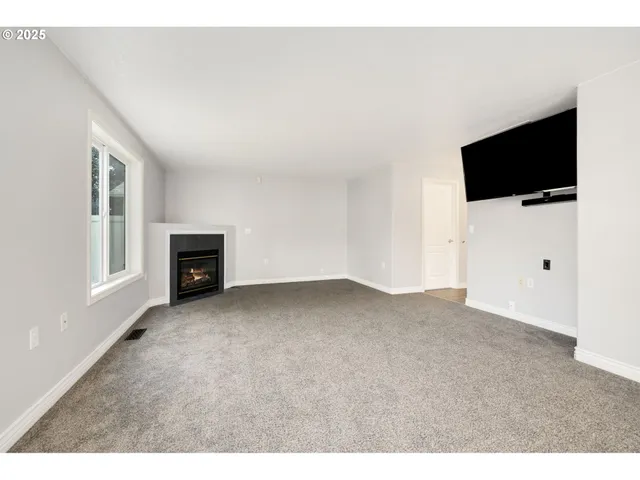 a view of an empty room with a flat screen tv