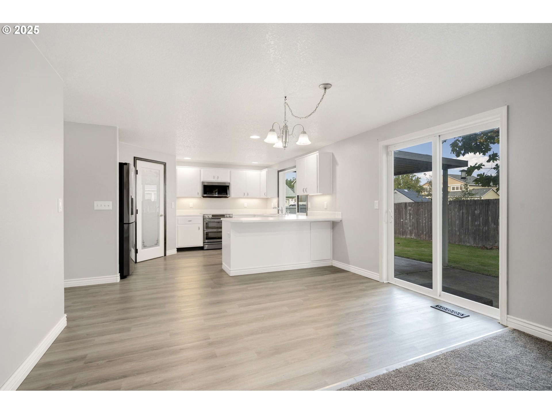 1311 Northwest 26th Avenue Battle Ground, WA 98604 - Photo 17 of 44 a view of a kitchen with wooden floor and a kitchen