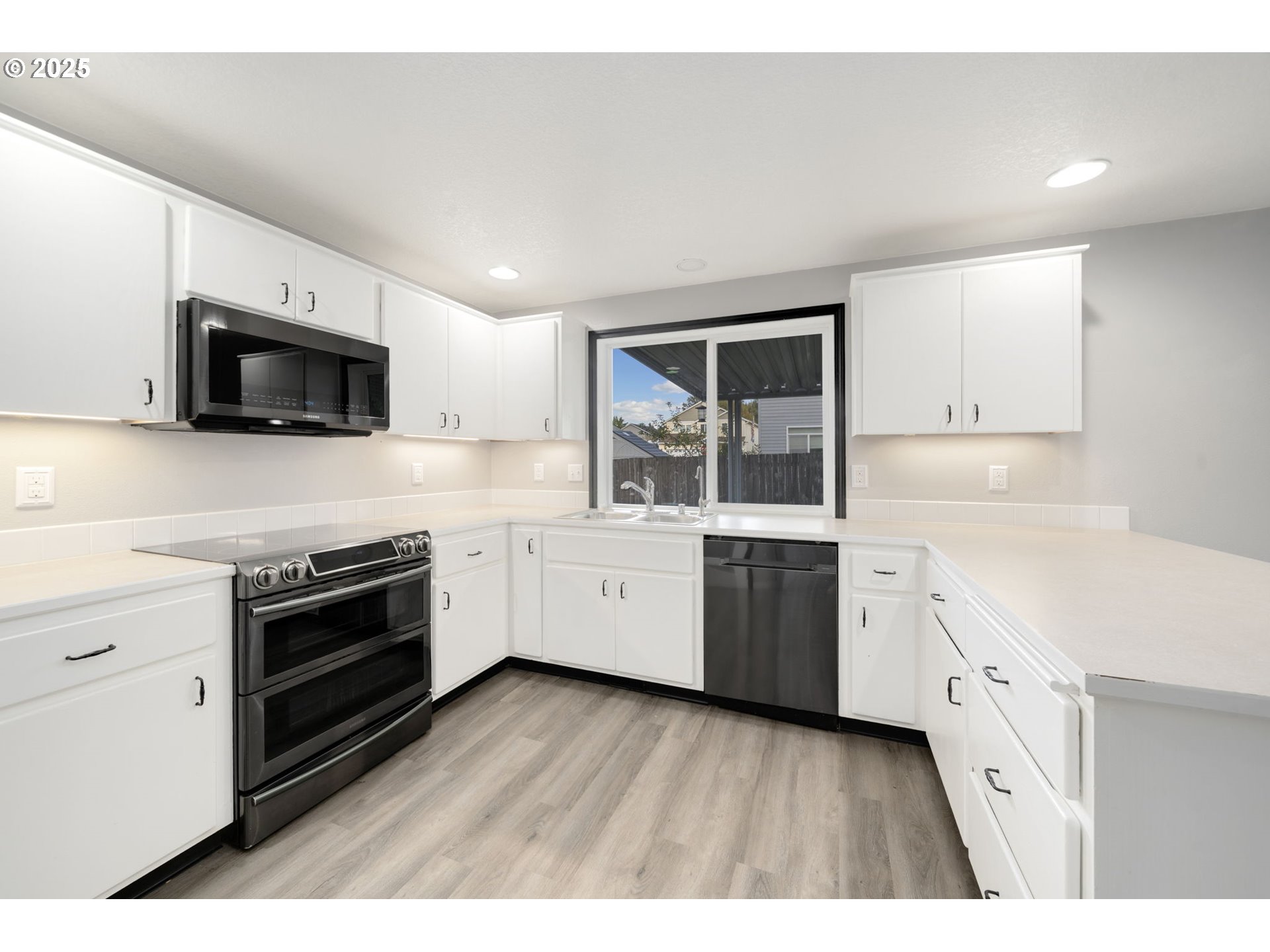 1311 Northwest 26th Avenue Battle Ground, WA 98604 - Photo 19 of 44 a kitchen with granite countertop a stove top oven sink and cabinets