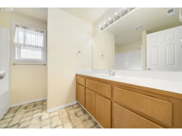 a bathroom with a sink a mirror and a shower