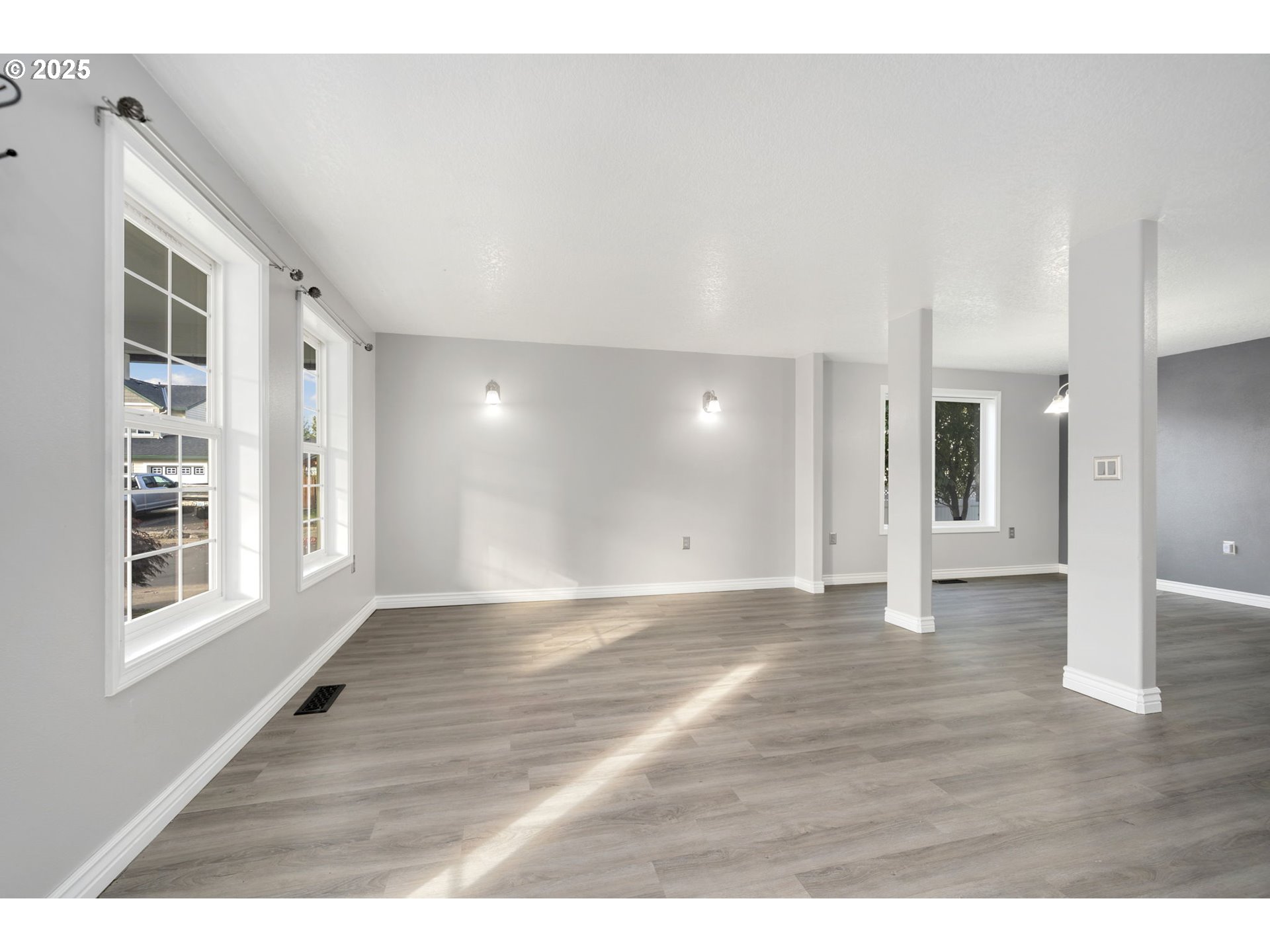 1311 Northwest 26th Avenue Battle Ground, WA 98604 - Photo 5 of 44 a view of an empty room with window and wooden floor