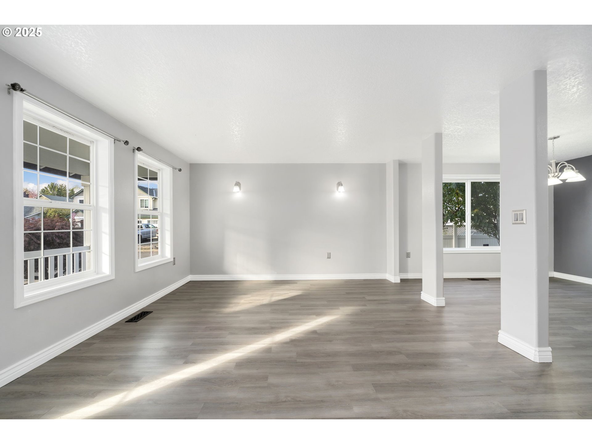 1311 Northwest 26th Avenue Battle Ground, WA 98604 - Photo 6 of 44 a view of an empty room with wooden floor and windows