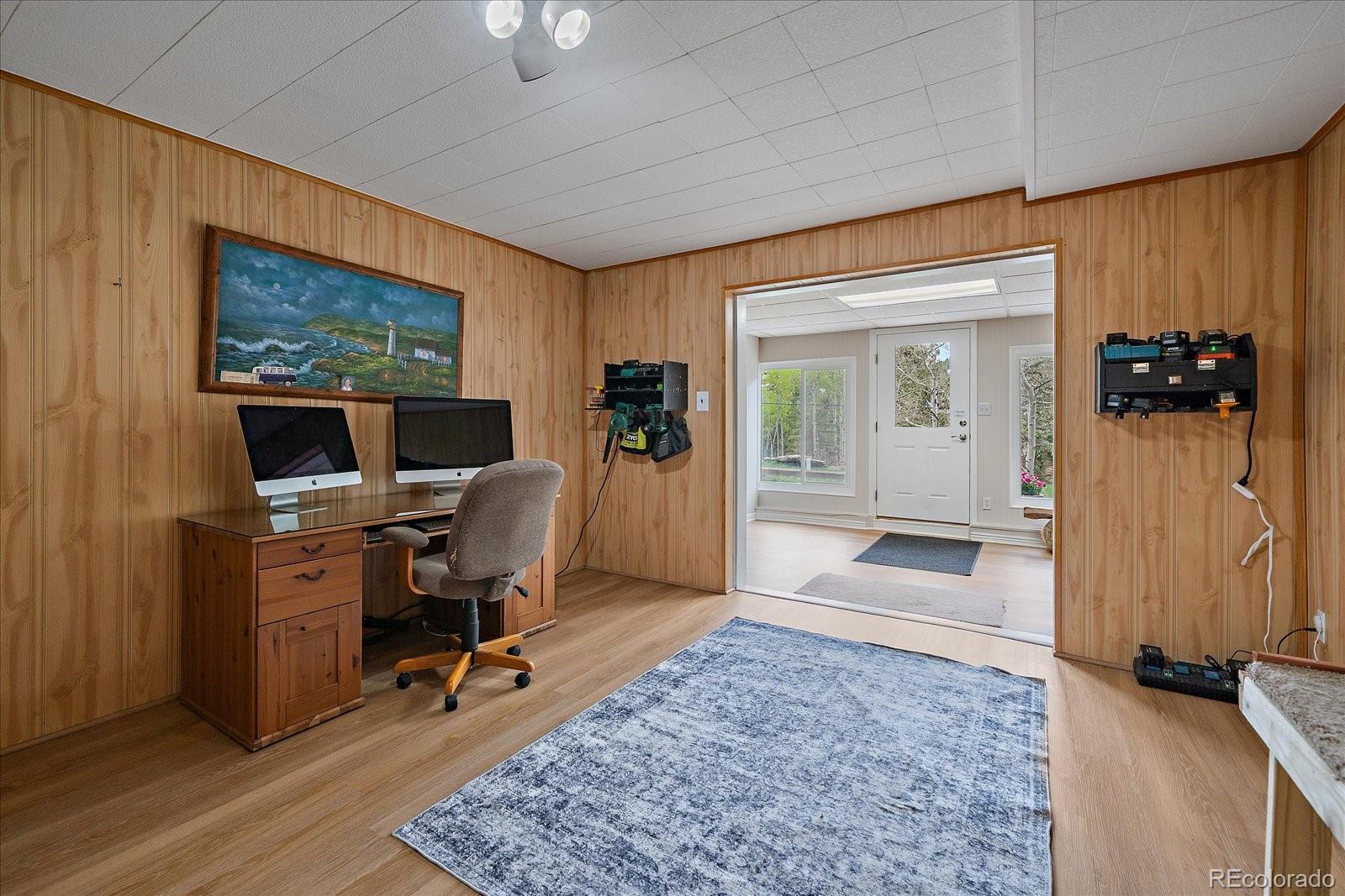 307 Snyder Mountain Road Evergreen, CO 80439 - Photo 29 of 41 a view of a workspace with furniture and a window