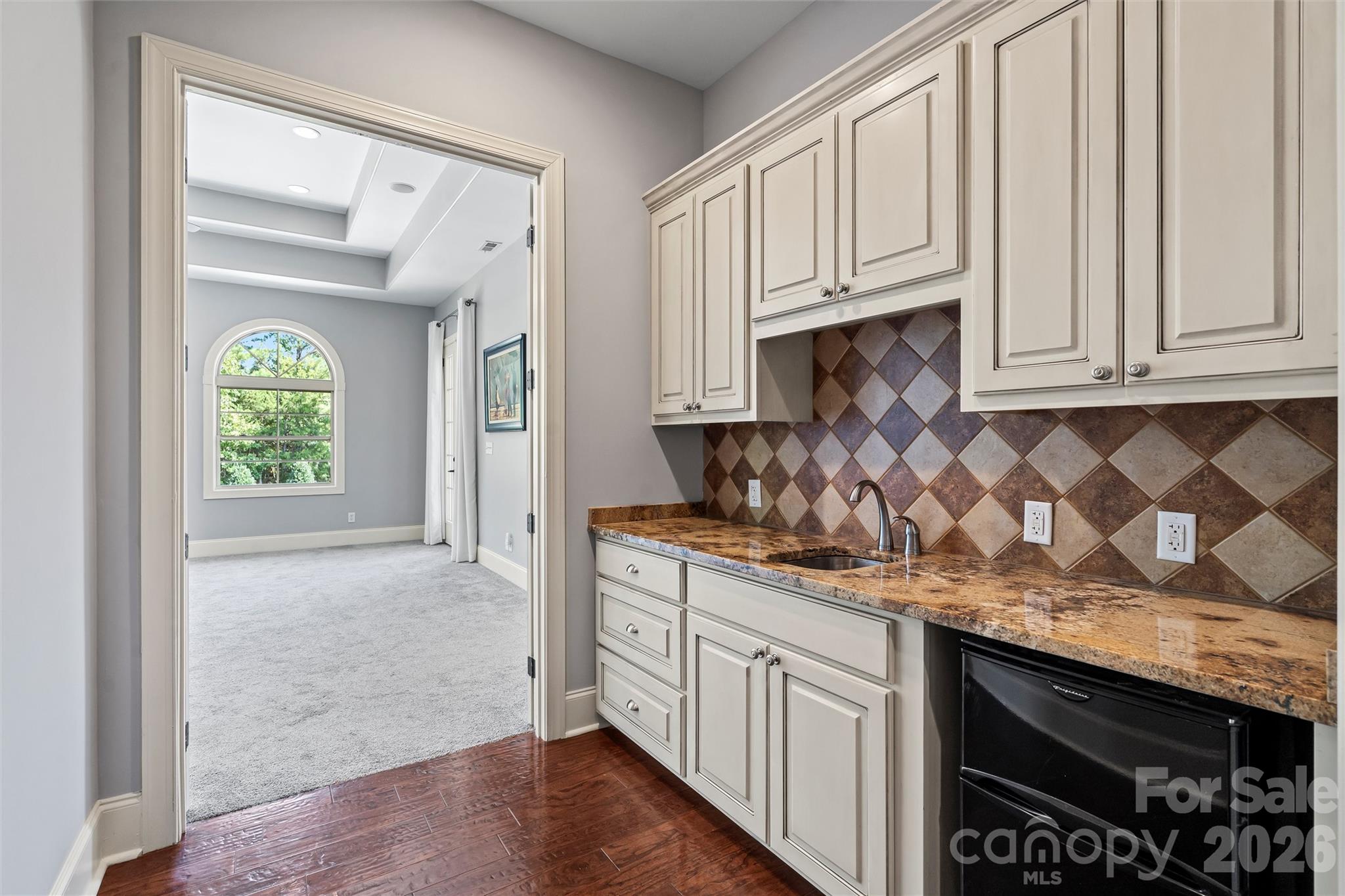 220 Fincher Road Pauline, SC 29374 - Photo 40 of 48 a kitchen with granite countertop white cabinets and stainless steel appliances