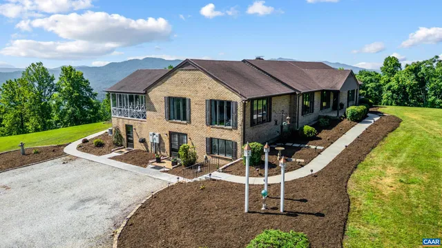 a front view of house with yard and outdoor seating