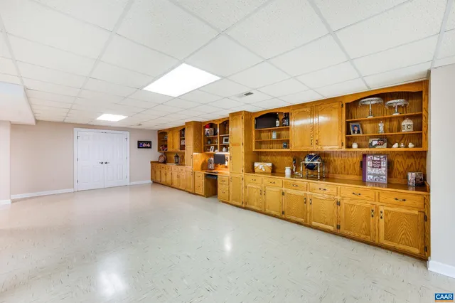 a view of a swimming pool with a patio and fire pit