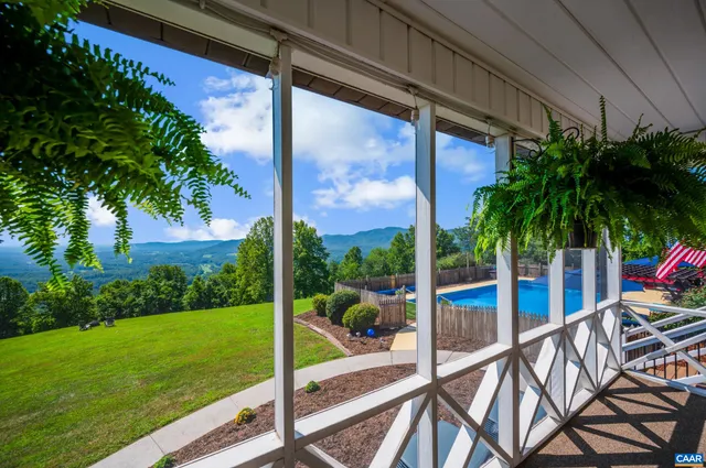 a view of a lush green hillside and a building