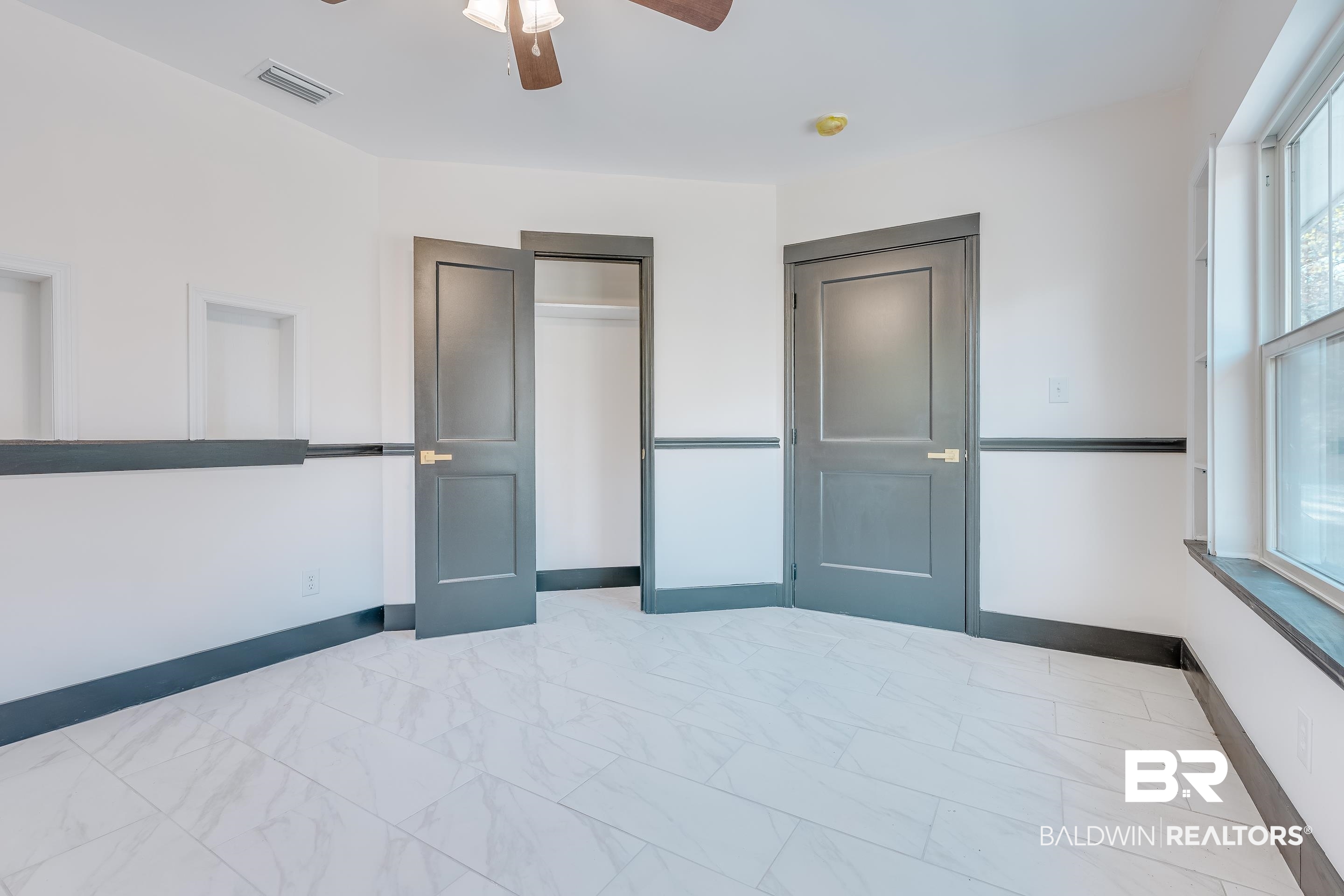 1190 Military Road Mount Vernon, AL 36560 - Photo 32 of 47 Unfurnished bedroom featuring ceiling fan, a closet, and light marble finish flooring