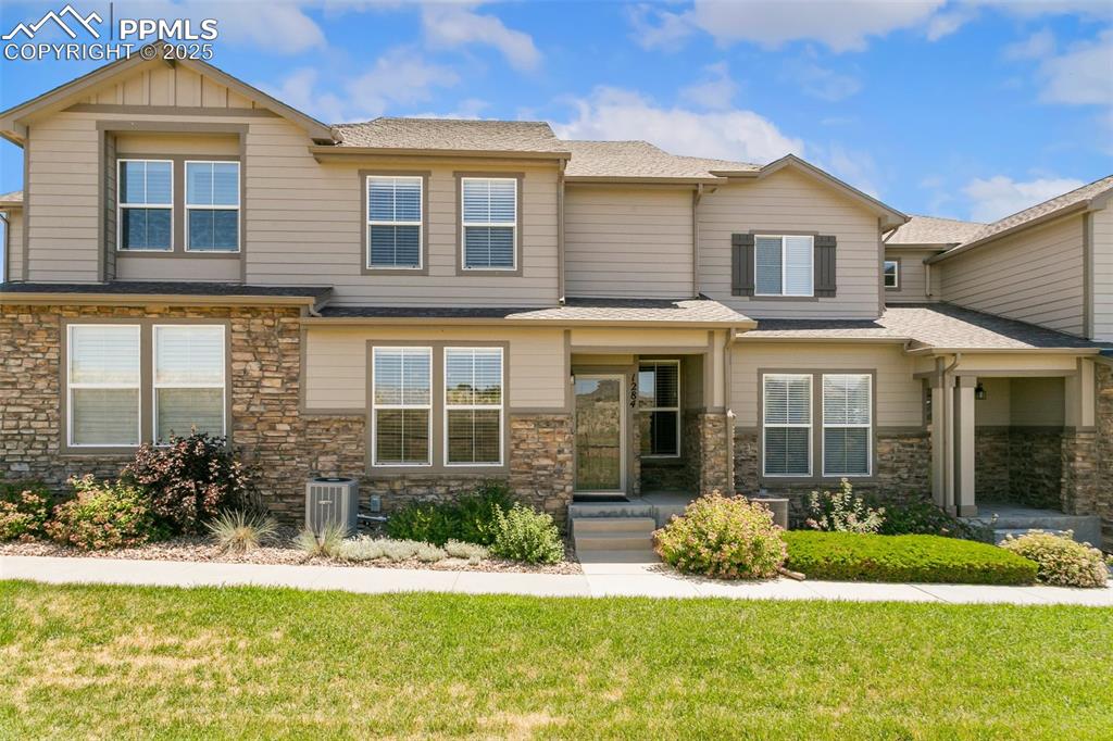 a front view of a house with a yard and porch
