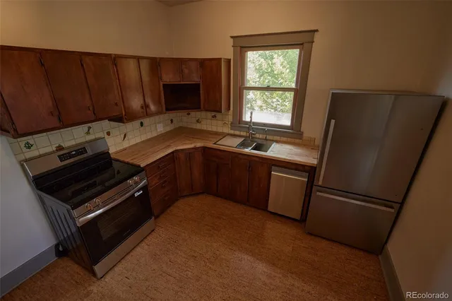 a kitchen with a refrigerator stove and microwave