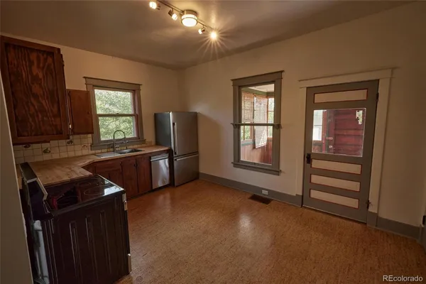 a kitchen with refrigerator and window