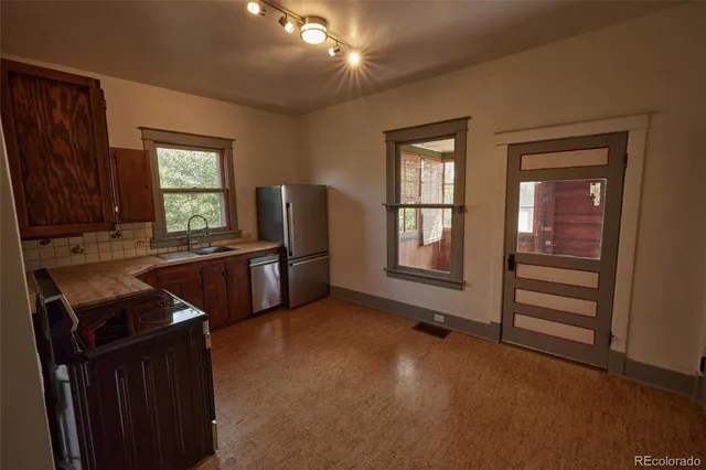 a kitchen with refrigerator and window