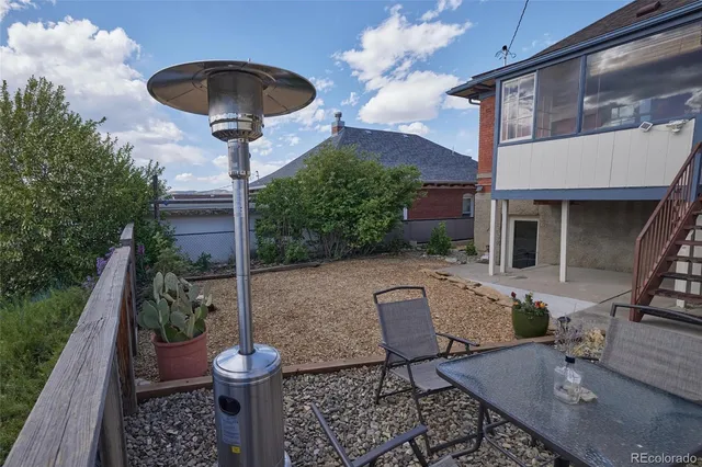 a view of brick house with a yard