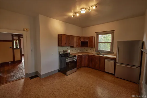 a kitchen with a refrigerator and a sink