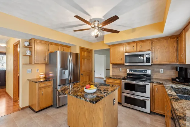 a kitchen with stainless steel appliances a stove a refrigerator and a sink