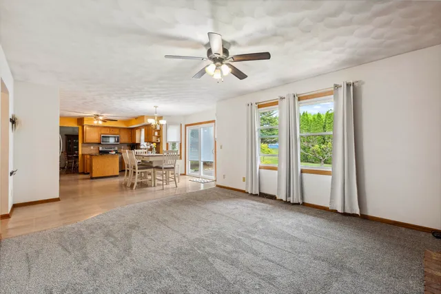 a view of a livingroom with furniture and a ceiling fan