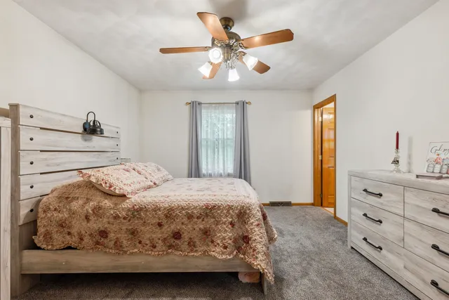 a bedroom with a bed and a dresser