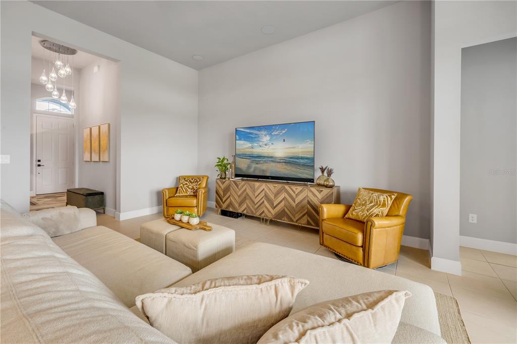 195 Azure Mist Way Daytona Beach, FL 32124 - Photo 16 of 63 a living room with couches and a flat screen tv