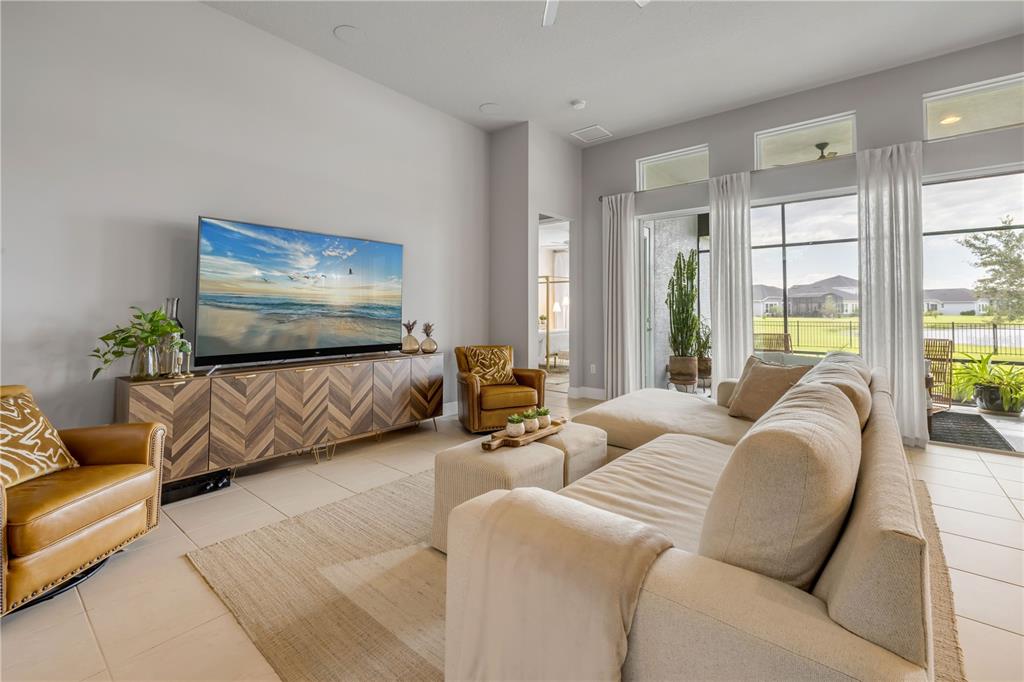195 Azure Mist Way Daytona Beach, FL 32124 - Photo 17 of 63 a living room with furniture ceiling fan and a flat screen tv