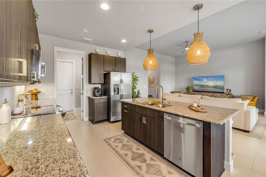 195 Azure Mist Way Daytona Beach, FL 32124 - Photo 22 of 63 a kitchen with stainless steel appliances granite countertop a sink a stove and a refrigerator