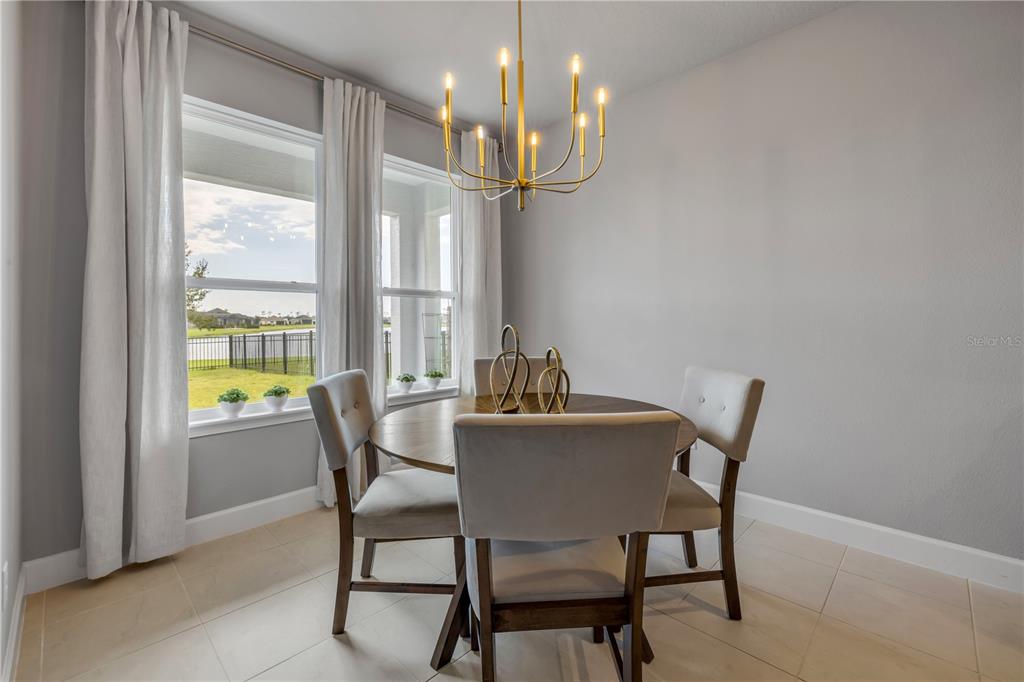 195 Azure Mist Way Daytona Beach, FL 32124 - Photo 26 of 63 a view of a dining room with furniture wooden floor and chandelier