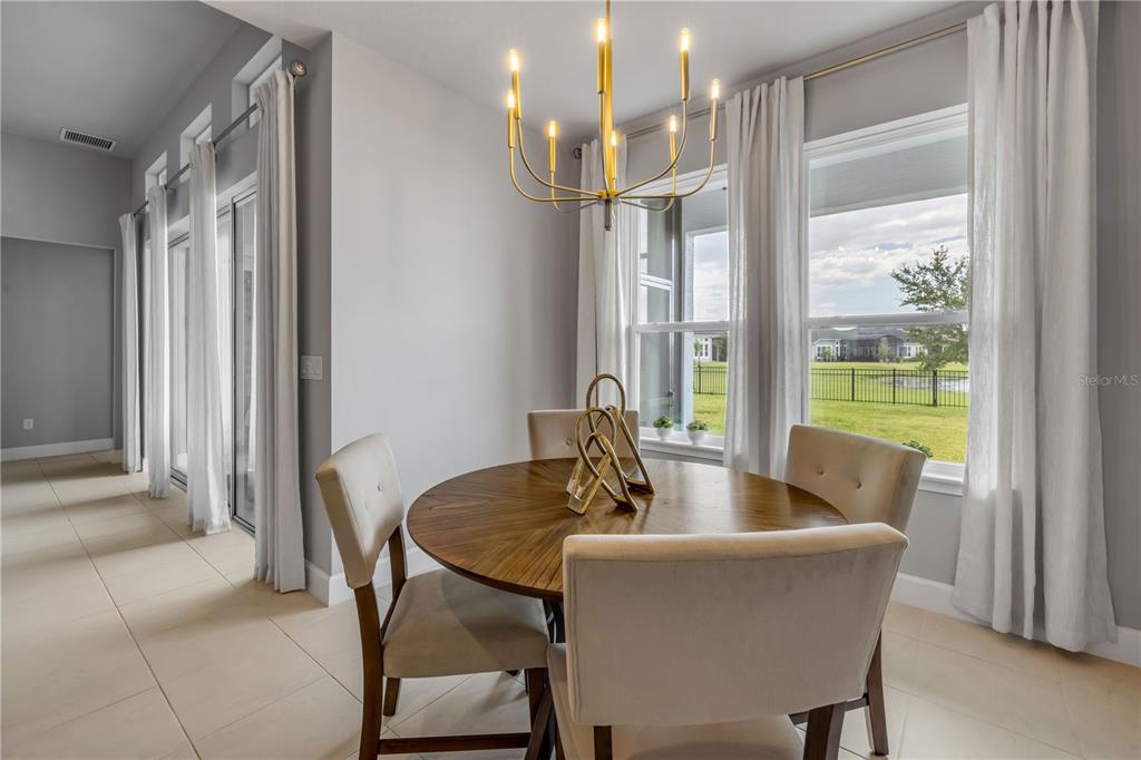 195 Azure Mist Way Daytona Beach, FL 32124 - Photo 27 of 63 a dining room with furniture and a floor to ceiling window