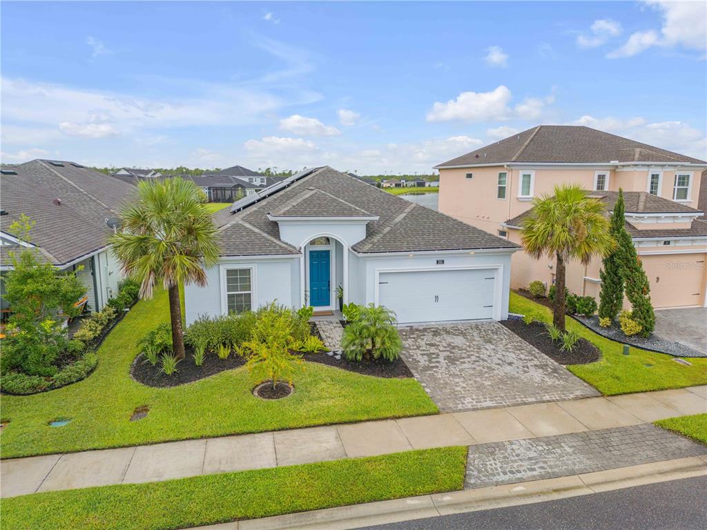 195 Azure Mist Way Daytona Beach, FL 32124 - Photo 3 of 63 a front view of a house with a yard and garage