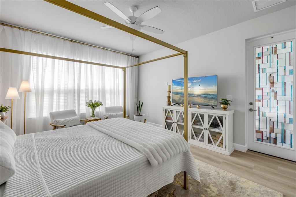 195 Azure Mist Way Daytona Beach, FL 32124 - Photo 31 of 63 a bedroom with furniture a flat screen tv and a window