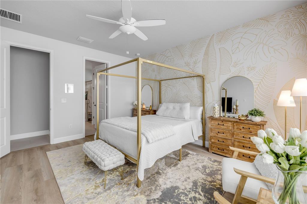 195 Azure Mist Way Daytona Beach, FL 32124 - Photo 32 of 63 a bedroom with a large bed and a chandelier