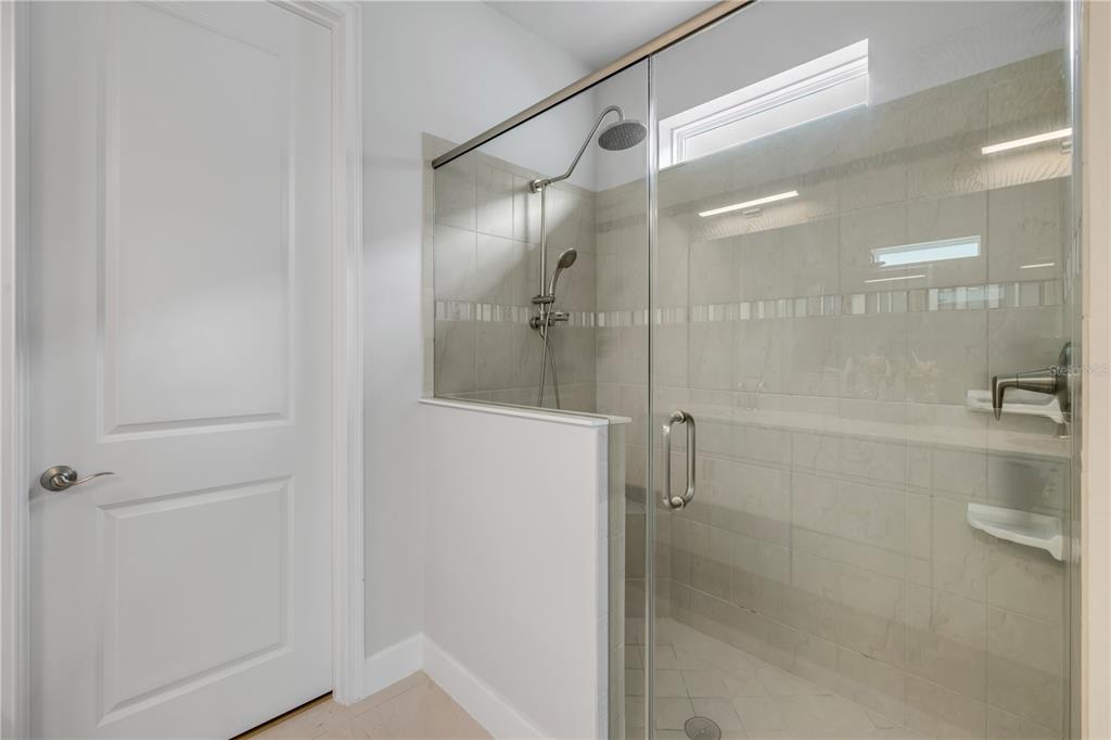 195 Azure Mist Way Daytona Beach, FL 32124 - Photo 36 of 63 a bathroom with a glass shower door